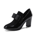 Large size black patent leather women's high heel shoe with a thick heel over 8cm.