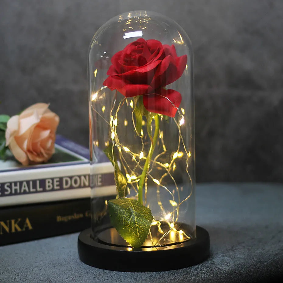 Artificial rose bouquet in glass dome with LED light on solid wood base