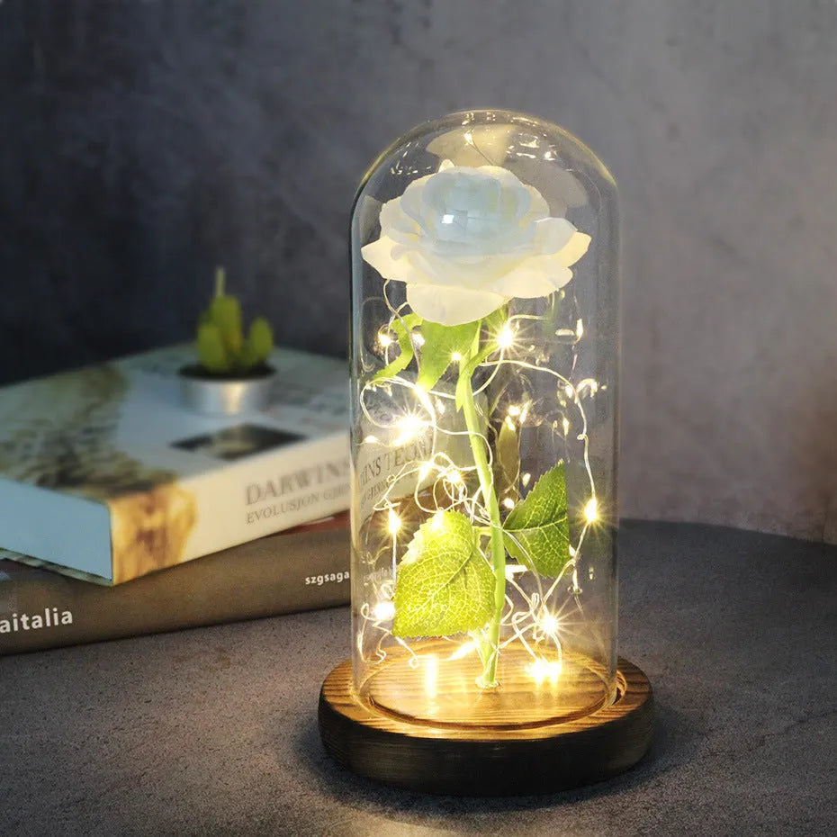 Artificial rose bouquet in glass dome with LED light on solid wood base