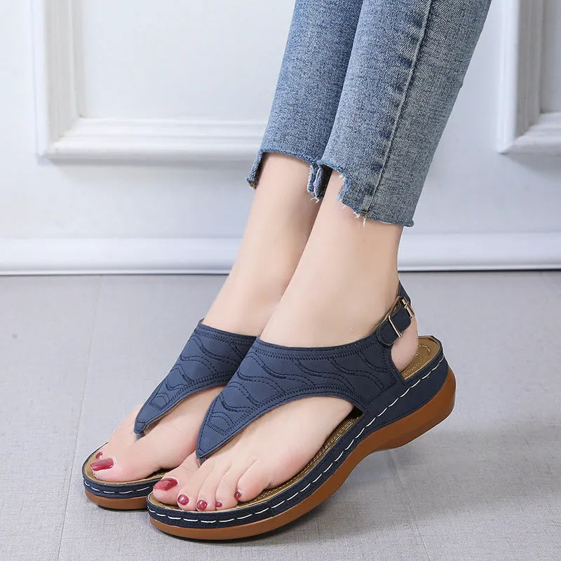 Women's casual wedge heel flip flop sandals with an adjustable buckle strap in solid colours.