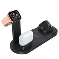 A black three-in-one wireless charging bracket holding an iPhone, an Apple Watch, and a set of wireless headphones.