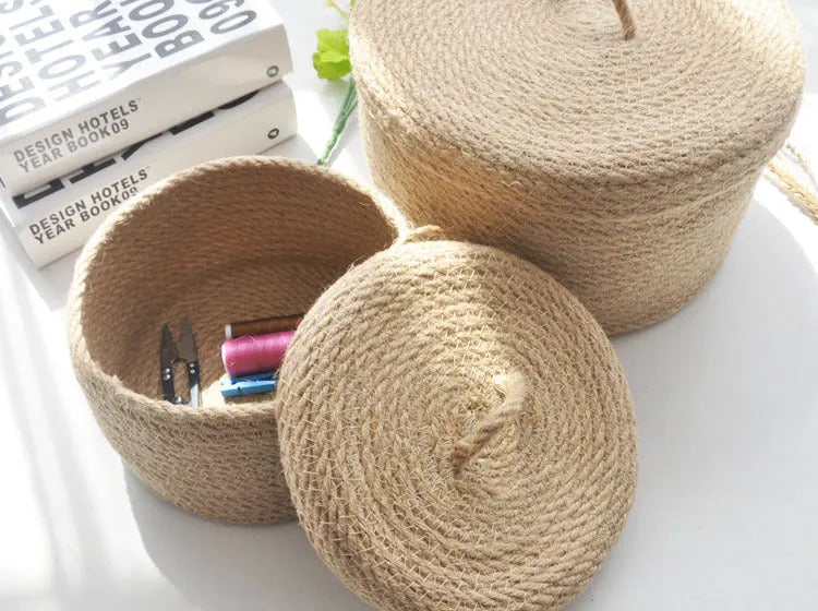 Japanese style fabric storage basket with a fitted lid in three sizes on a table.