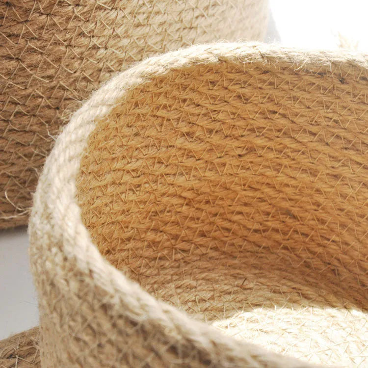Japanese style fabric storage basket with a fitted lid in three sizes on a table.
