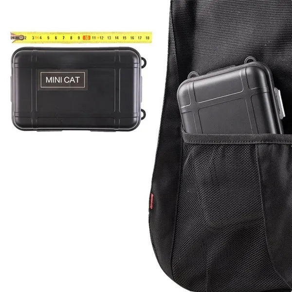Open black shockproof box displaying 13-piece stainless steel survival tool kit including compass, flashlight, and saber.