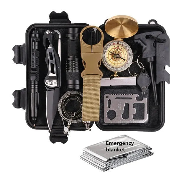 Open black shockproof box displaying 13-piece stainless steel survival tool kit including compass, flashlight, and saber.