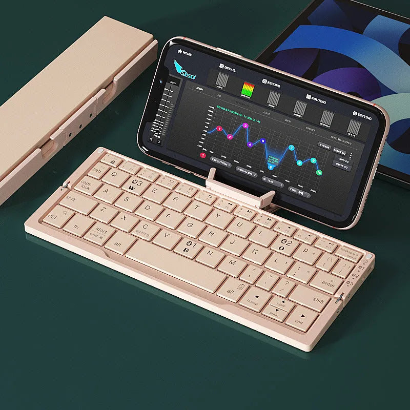 Silver aluminium folding Bluetooth keyboard with stand holding smartphone