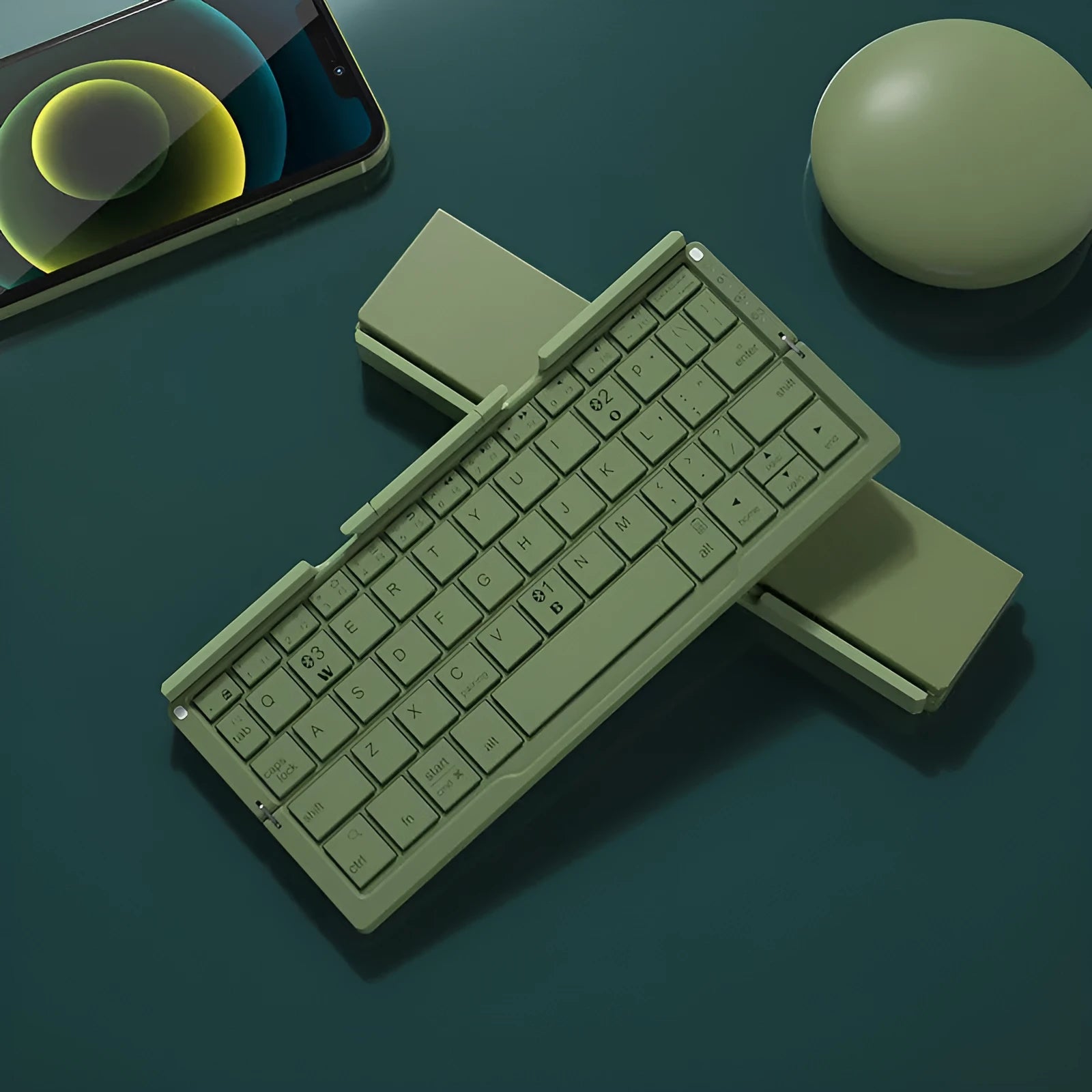 Silver aluminium folding Bluetooth keyboard with stand holding smartphone