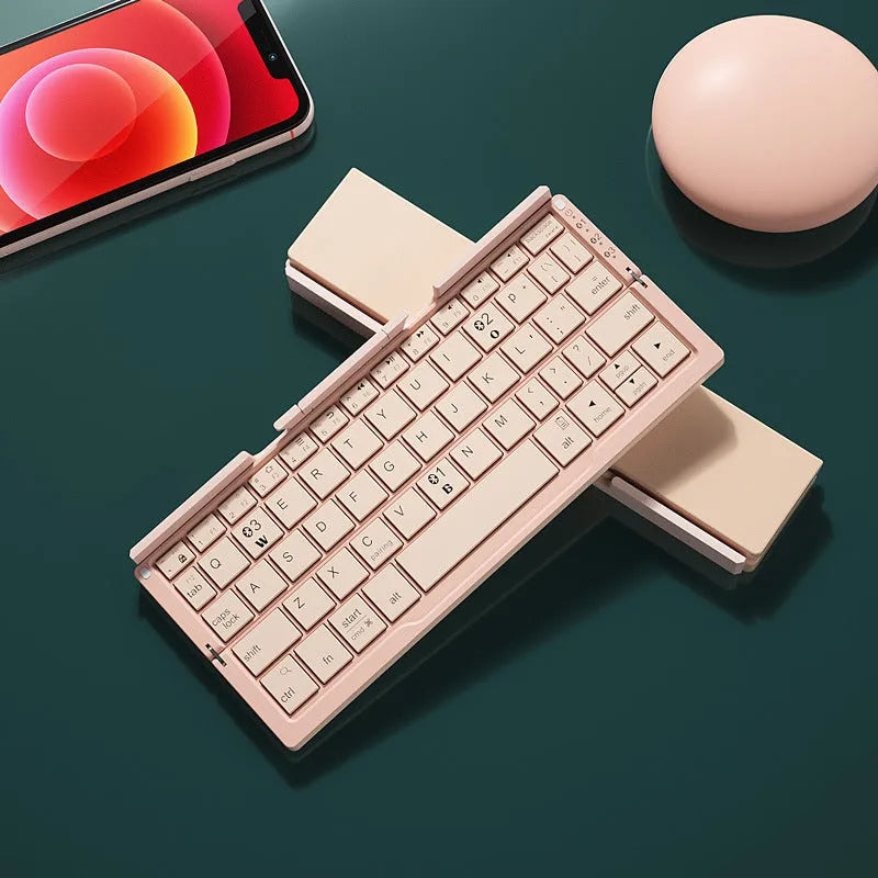 Silver aluminium folding Bluetooth keyboard with stand holding smartphone
