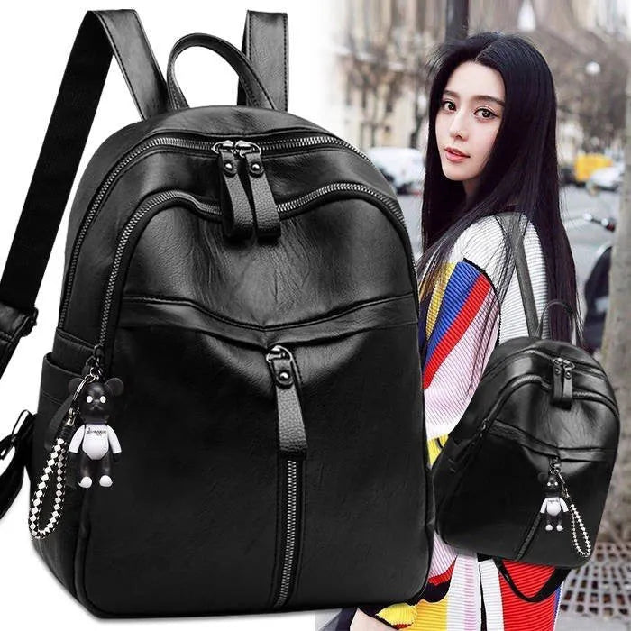 Medium black backpack in soft surface PU leather with double shoulder straps showing zipper closure