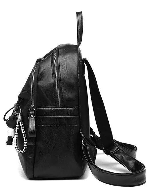 Medium black backpack in soft surface PU leather with double shoulder straps showing zipper closure