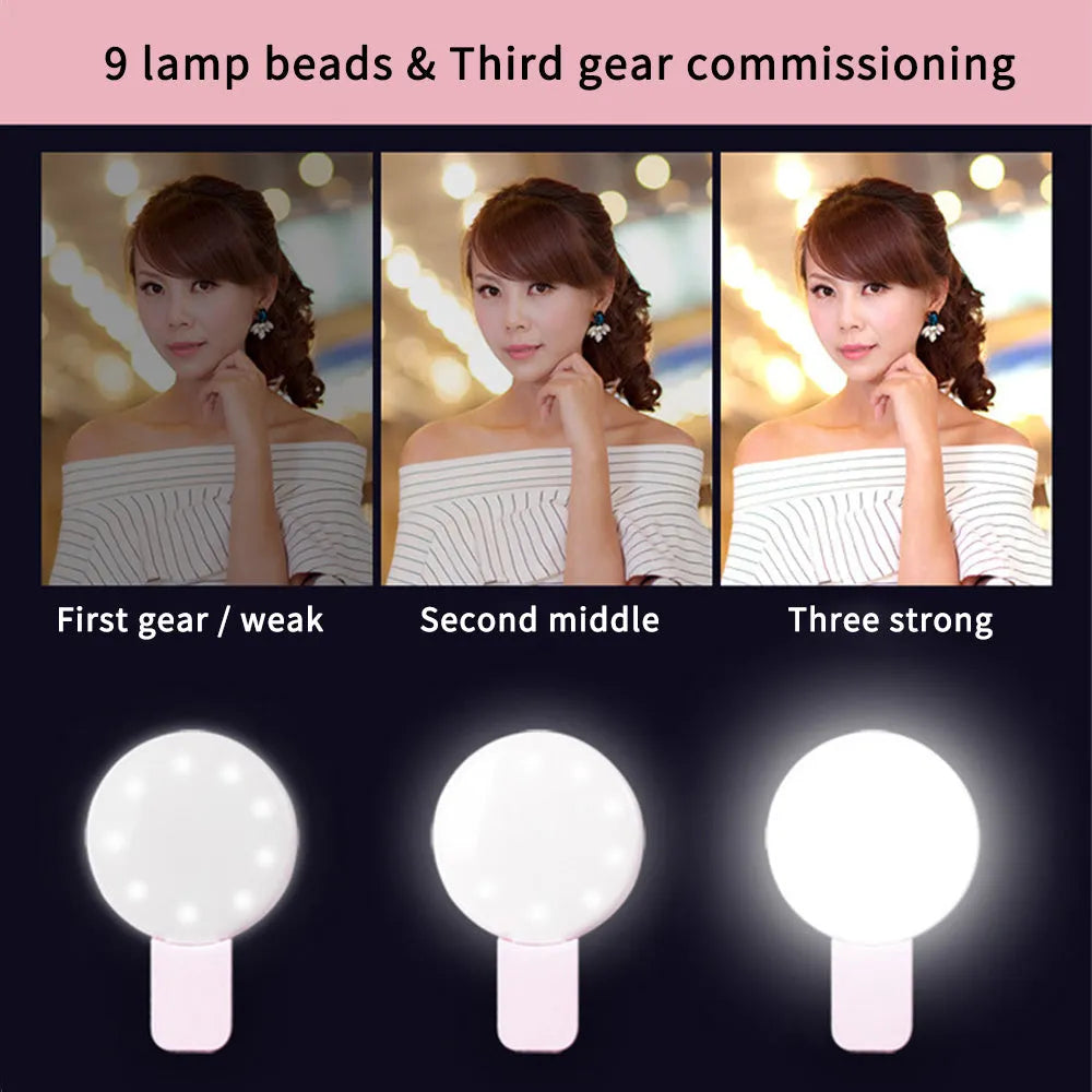 Small round white LED fill light clipped onto a mobile phone for taking selfies.
