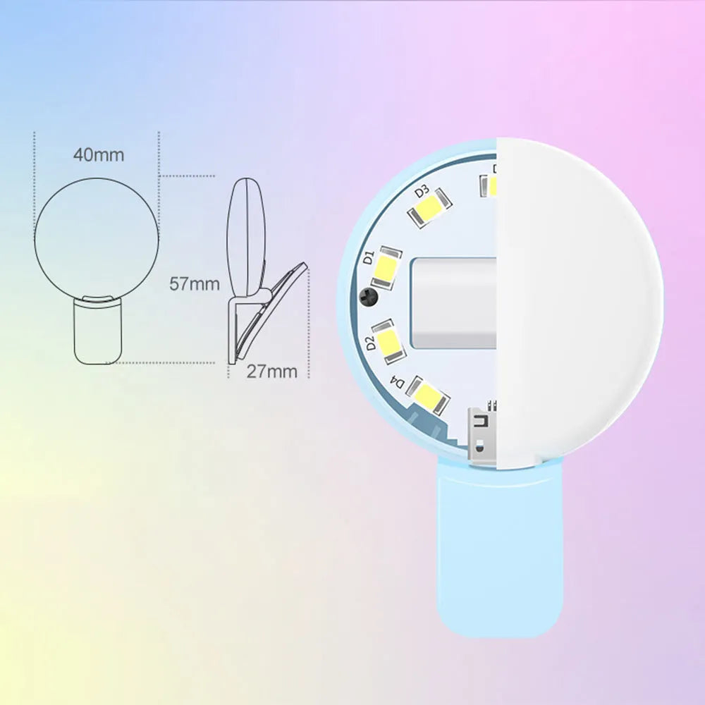 Small round white LED fill light clipped onto a mobile phone for taking selfies.