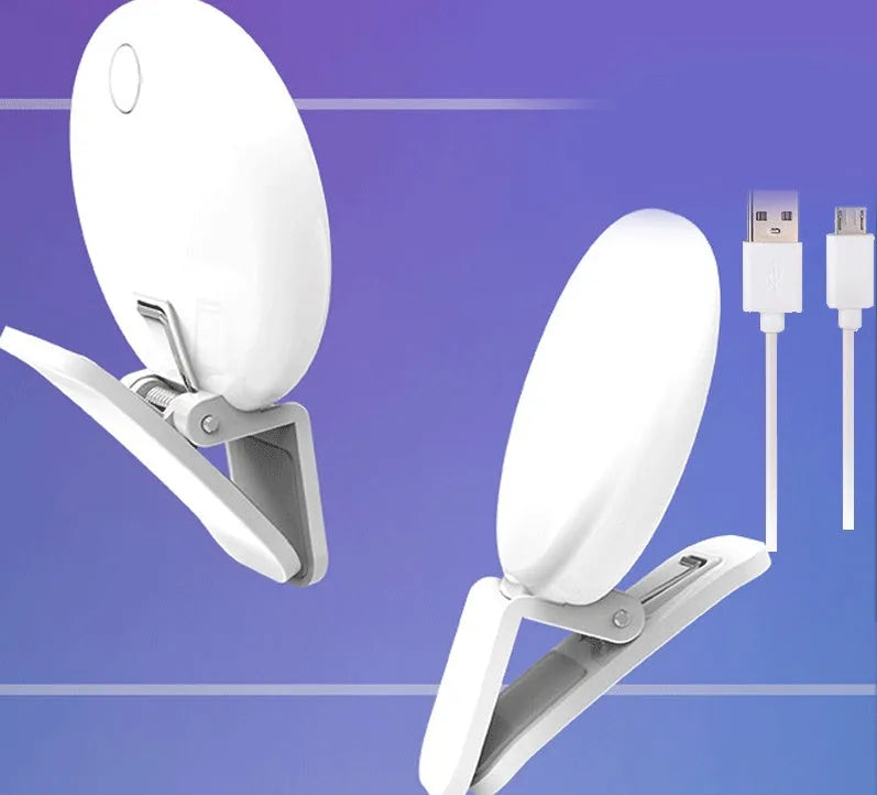 Small round white LED fill light clipped onto a mobile phone for taking selfies.