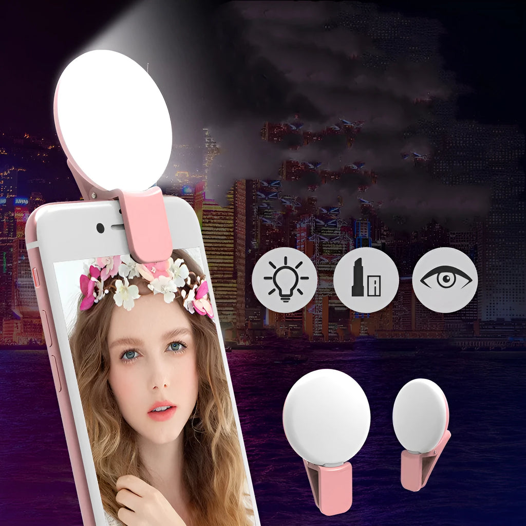 Small round white LED fill light clipped onto a mobile phone for taking selfies.
