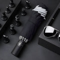 Automatic reverse umbrella with black canopy showing reverse closing mechanism and plastic handle
