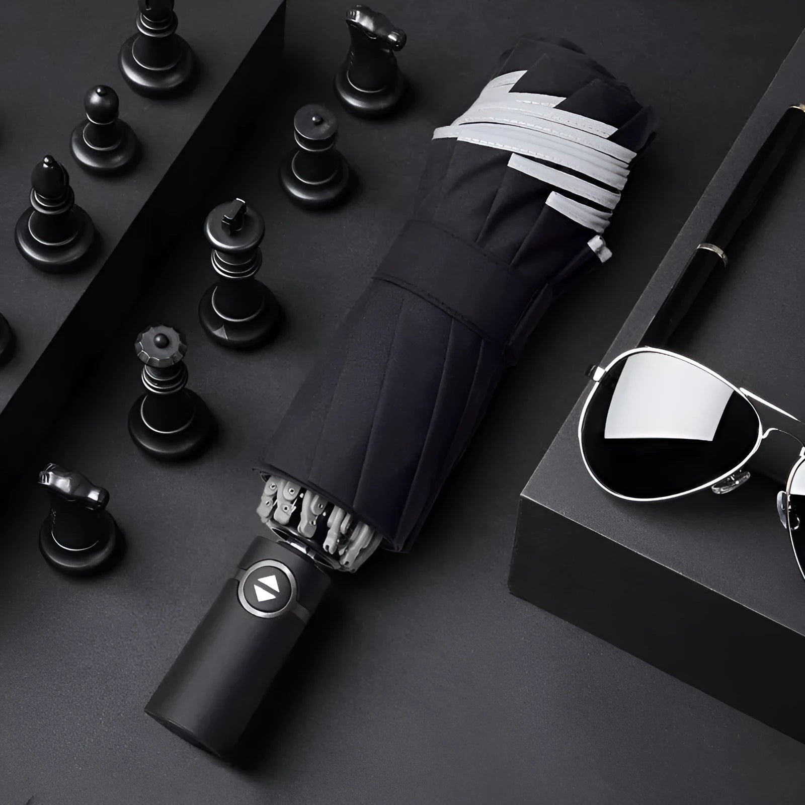 Automatic reverse umbrella with black canopy showing reverse closing mechanism and plastic handle