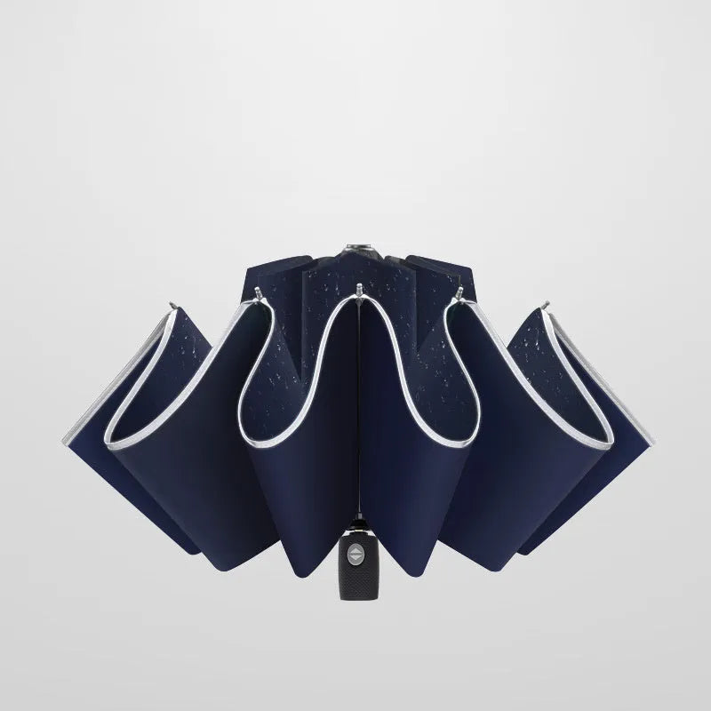 Automatic reverse umbrella with black canopy showing reverse closing mechanism and plastic handle