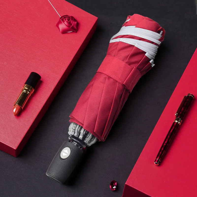 Automatic reverse umbrella with black canopy showing reverse closing mechanism and plastic handle