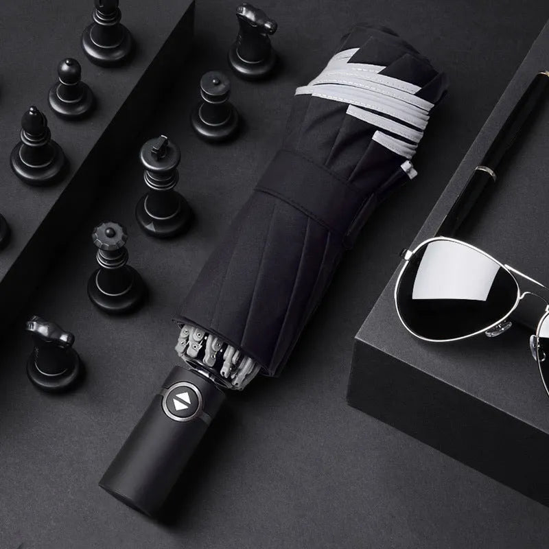 Automatic reverse umbrella with black canopy showing reverse closing mechanism and plastic handle