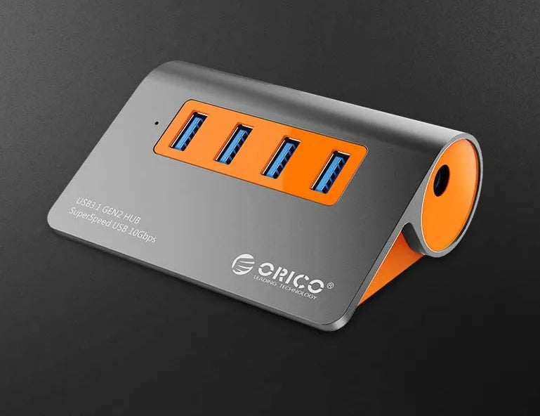 Dark grey USB-C laptop hub with four USB 3.1 ports and orange accents beside its separate 100cm cable