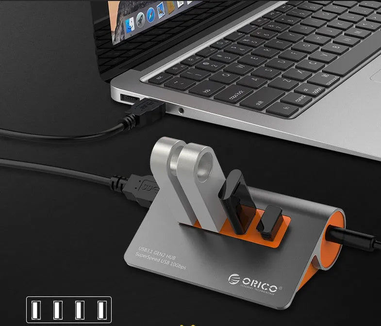 Dark grey USB-C laptop hub with four USB 3.1 ports and orange accents beside its separate 100cm cable
