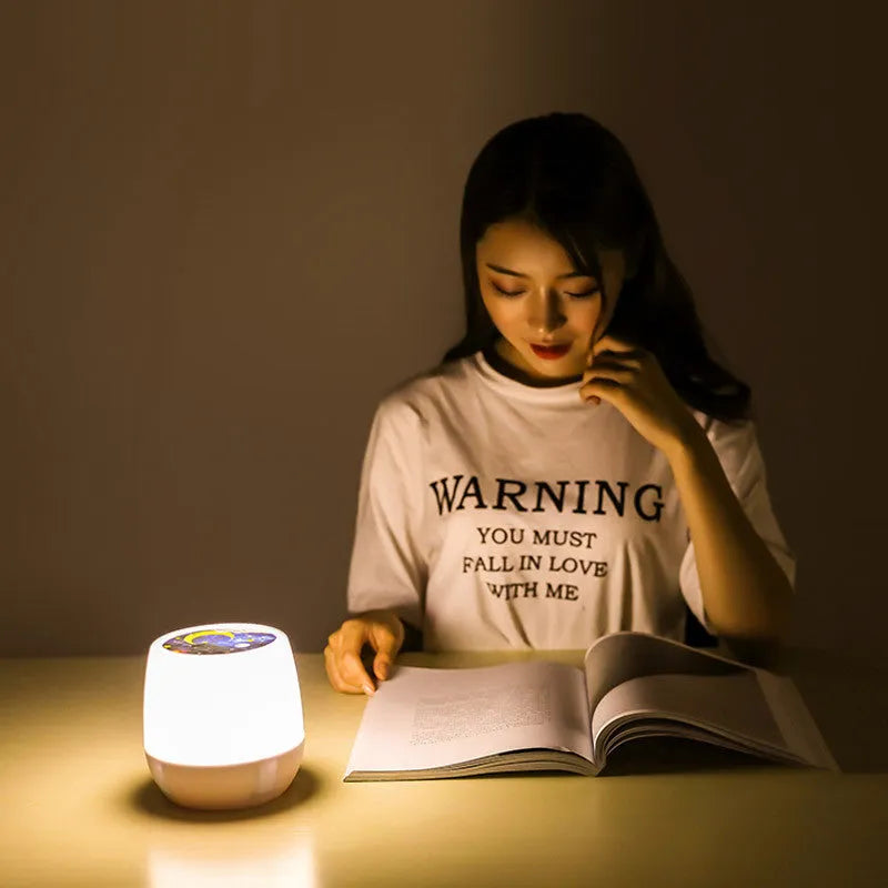 Projector night light projecting rotating starry sky patterns onto bedroom ceiling