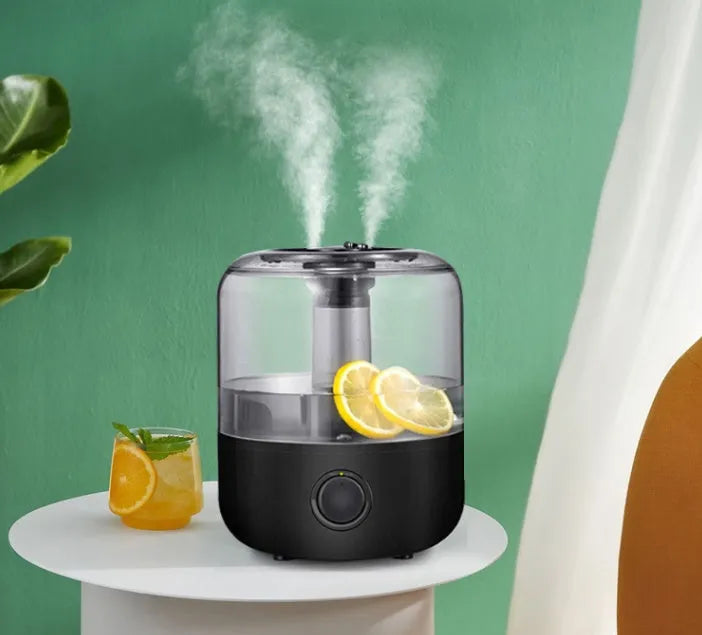 White mechanical humidifier with water tank and control dial on a wooden surface.