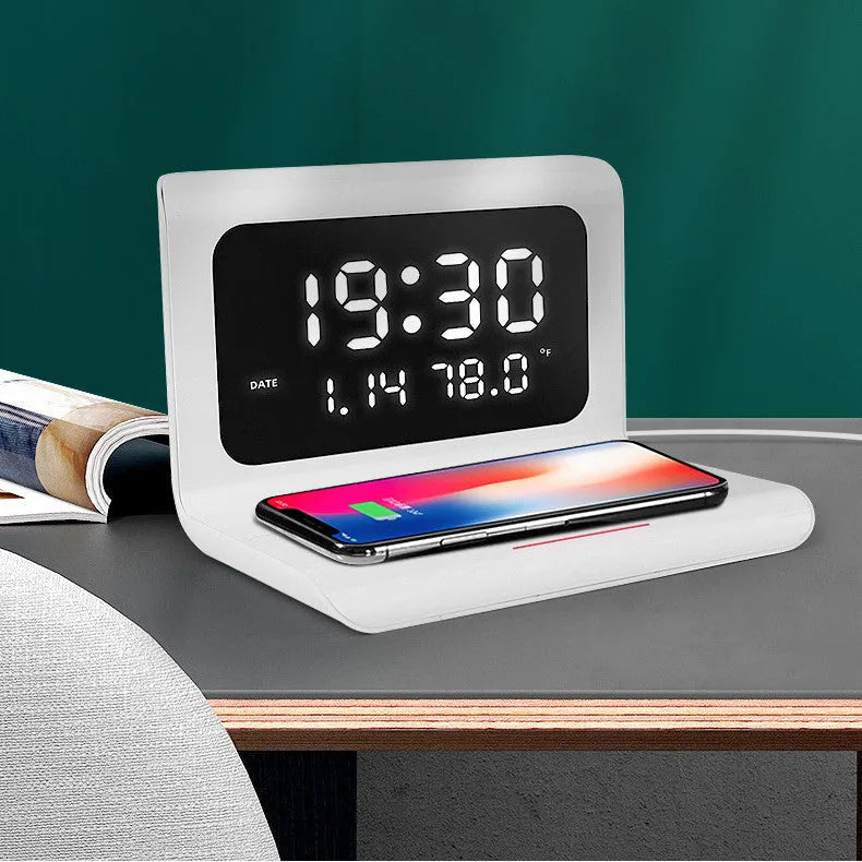 White wireless charger alarm clock showing time, date, temperature and humidity on digital display