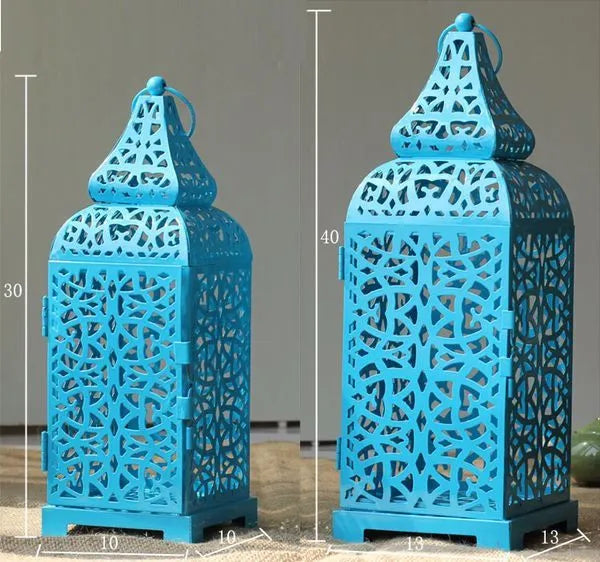 Moroccan-style geometric iron candelabra with hollow design and hanging ornaments, 14x14x38cm in blue, white, or yellow sets.