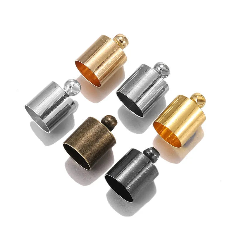 Assortment of small, dome-shaped copper caps in gold, silver, black, and bronze finishes for jewellery making.