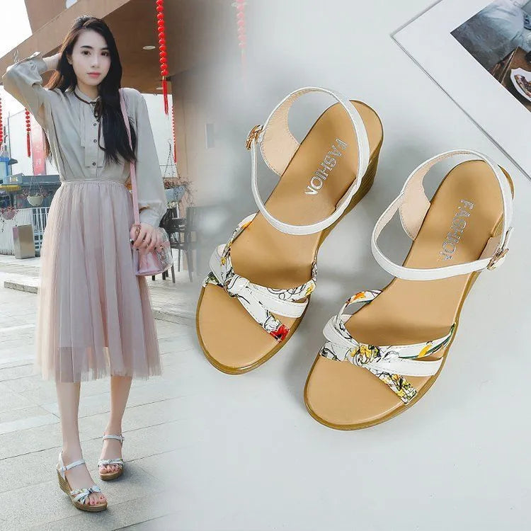 Women's pink wedge sandals with a thick heel, fish mouth toe, and an adjustable buckle strap.