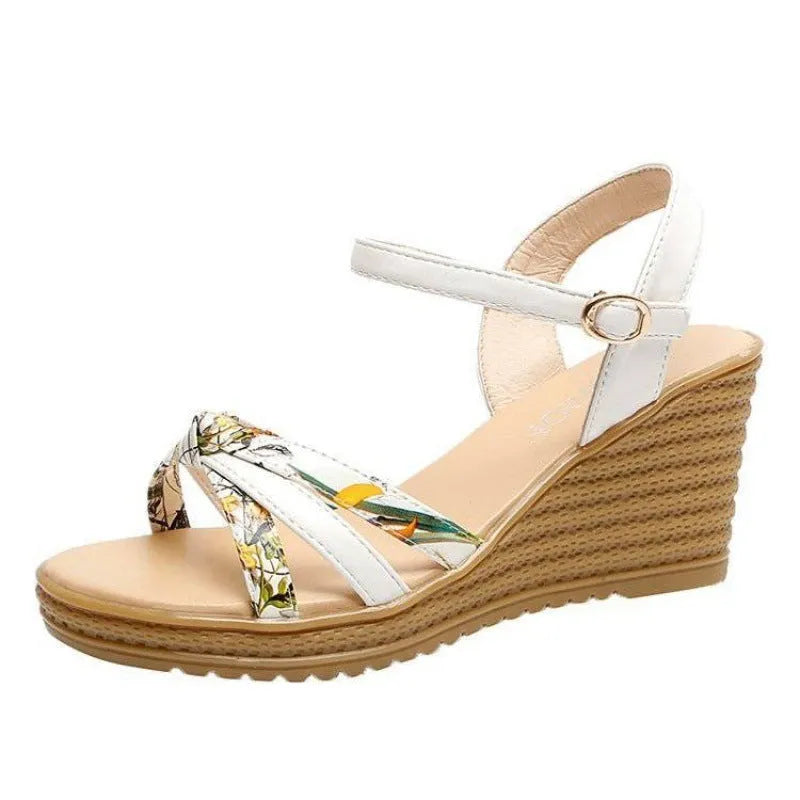 Women's pink wedge sandals with a thick heel, fish mouth toe, and an adjustable buckle strap.