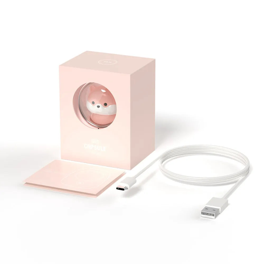 White handheld hanging neck fan with USB port and three speed buttons on a table.