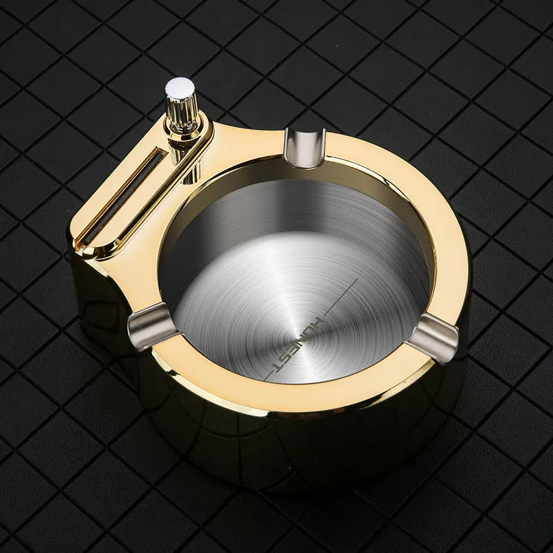 Blue metal ashtray with sliding permanent match lighter and three cigarette slots on a table.