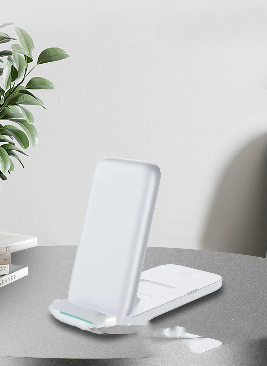 Black foldable three-in-one wireless charger shown open and closed next to a smartphone