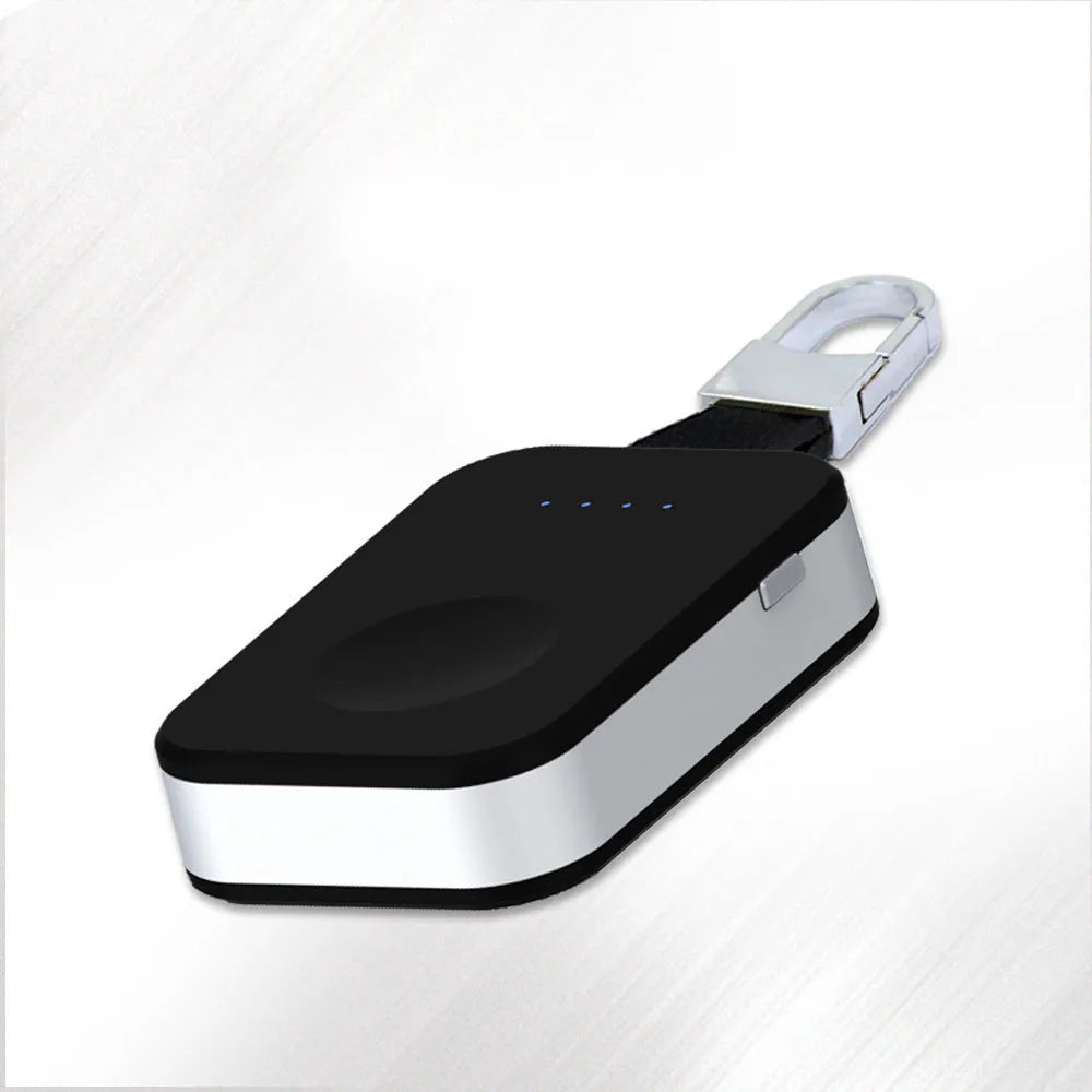Black Apple Watch portable wireless power bank with keychain ring, shown next to an Apple Watch.