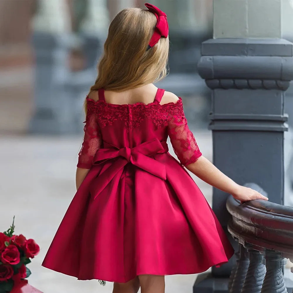 Girls red lace-trimmed dress with ruffle sleeves on a hanger