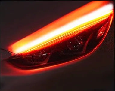 Flexible silicone car LED daytime running light strip with turn signal function, showing wire connections.