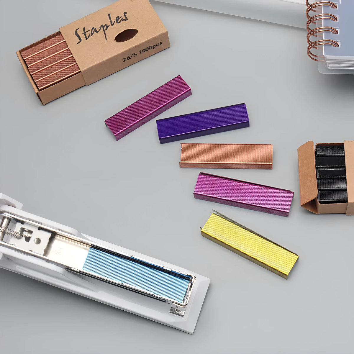 Box containing 1000 metal staples in colours black, purple, rose gold, and rose red.