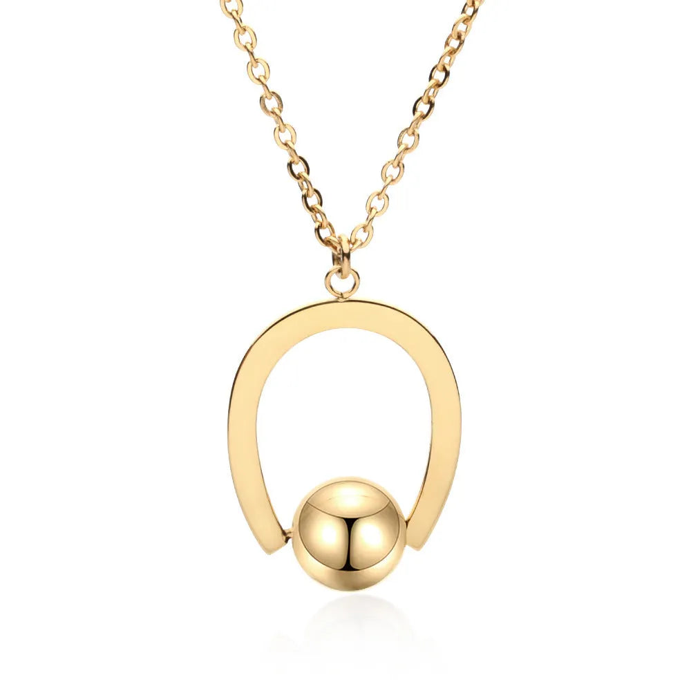 Stainless steel geometric pendant necklace on a cross chain, shown in gold colour.