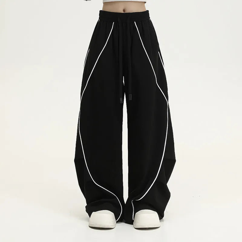Black pleated wide-leg hip hop sports trousers with a stripe pattern on a mannequin