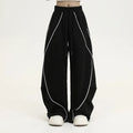 Black pleated wide-leg hip hop sports trousers with a stripe pattern on a mannequin