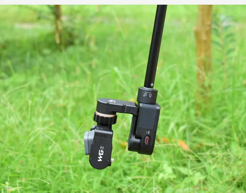 Black retractable selfie stick extended, showing smartphone mounted for a handheld shot.