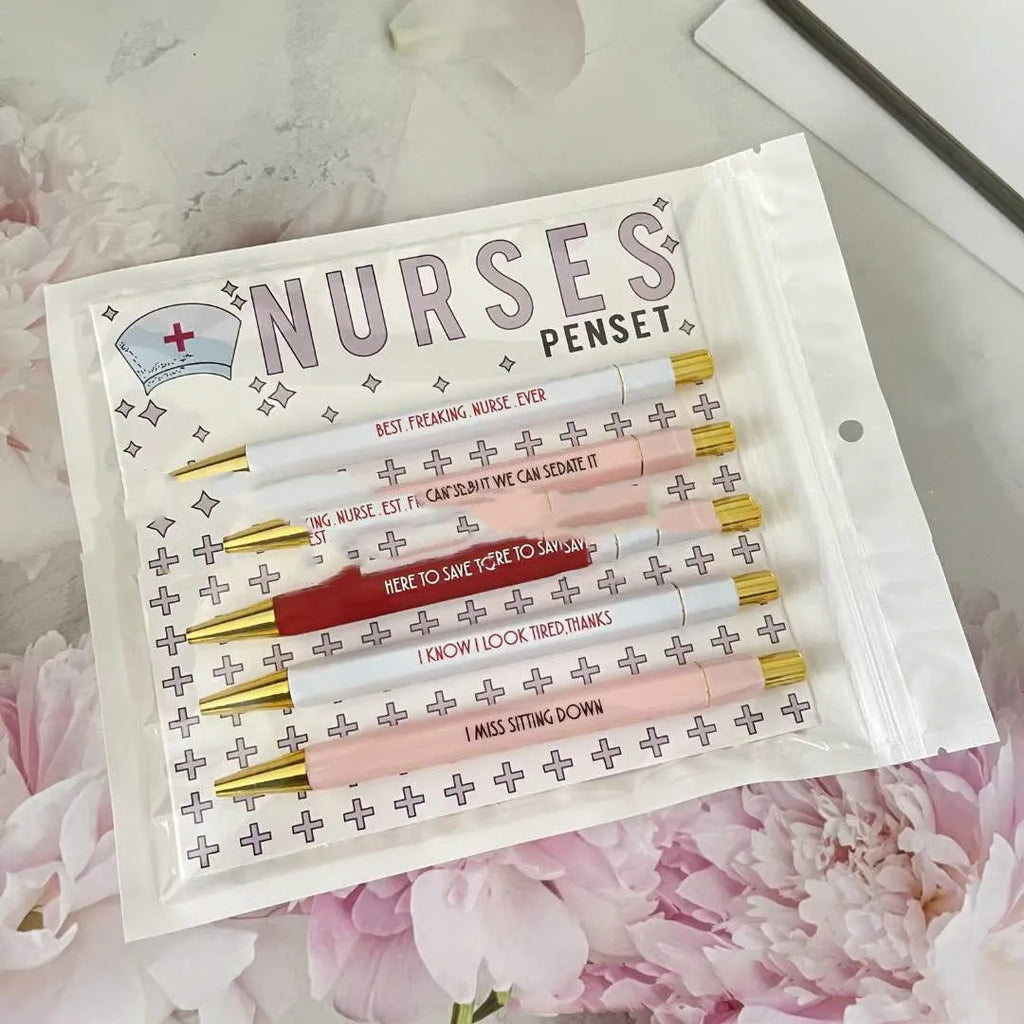 Set of five plastic nurse humour retractable ballpoint pens showing size.