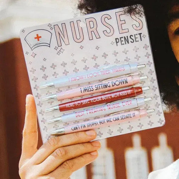 Set of five plastic nurse humour retractable ballpoint pens showing size.