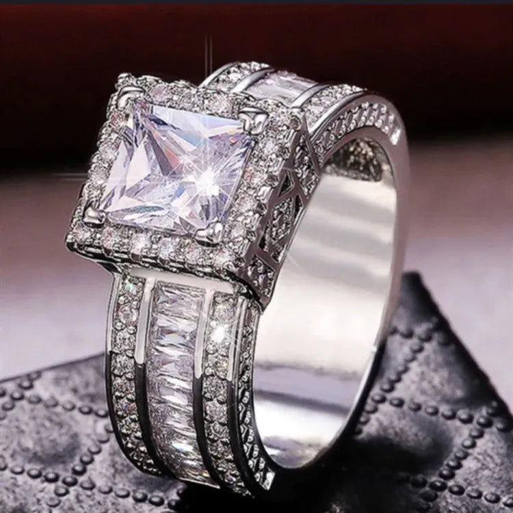Geometric alloy fashion ring in gold or white colour on size display showing UK sizes 5-13