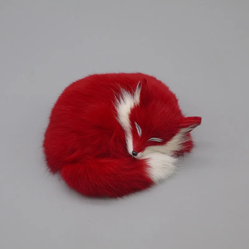 Artificial white fox fur car ornament measuring 15cm long on a car dashboard.