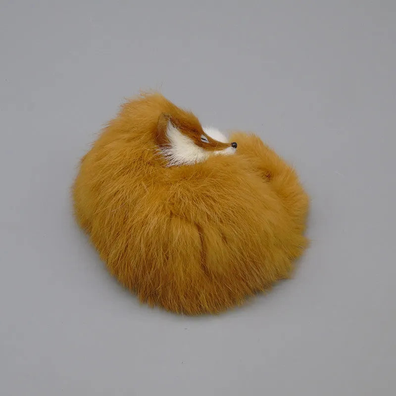 Artificial white fox fur car ornament measuring 15cm long on a car dashboard.