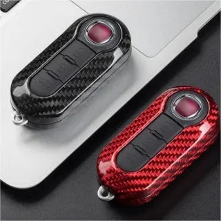 Carbon fibre and glass fibre replacement shell for a car key fob in black, red, and silver black finishes.