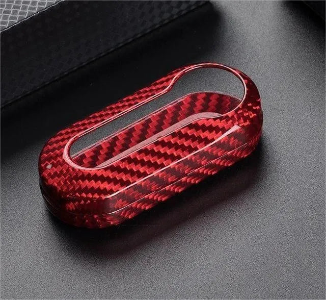 Carbon fibre and glass fibre replacement shell for a car key fob in black, red, and silver black finishes.